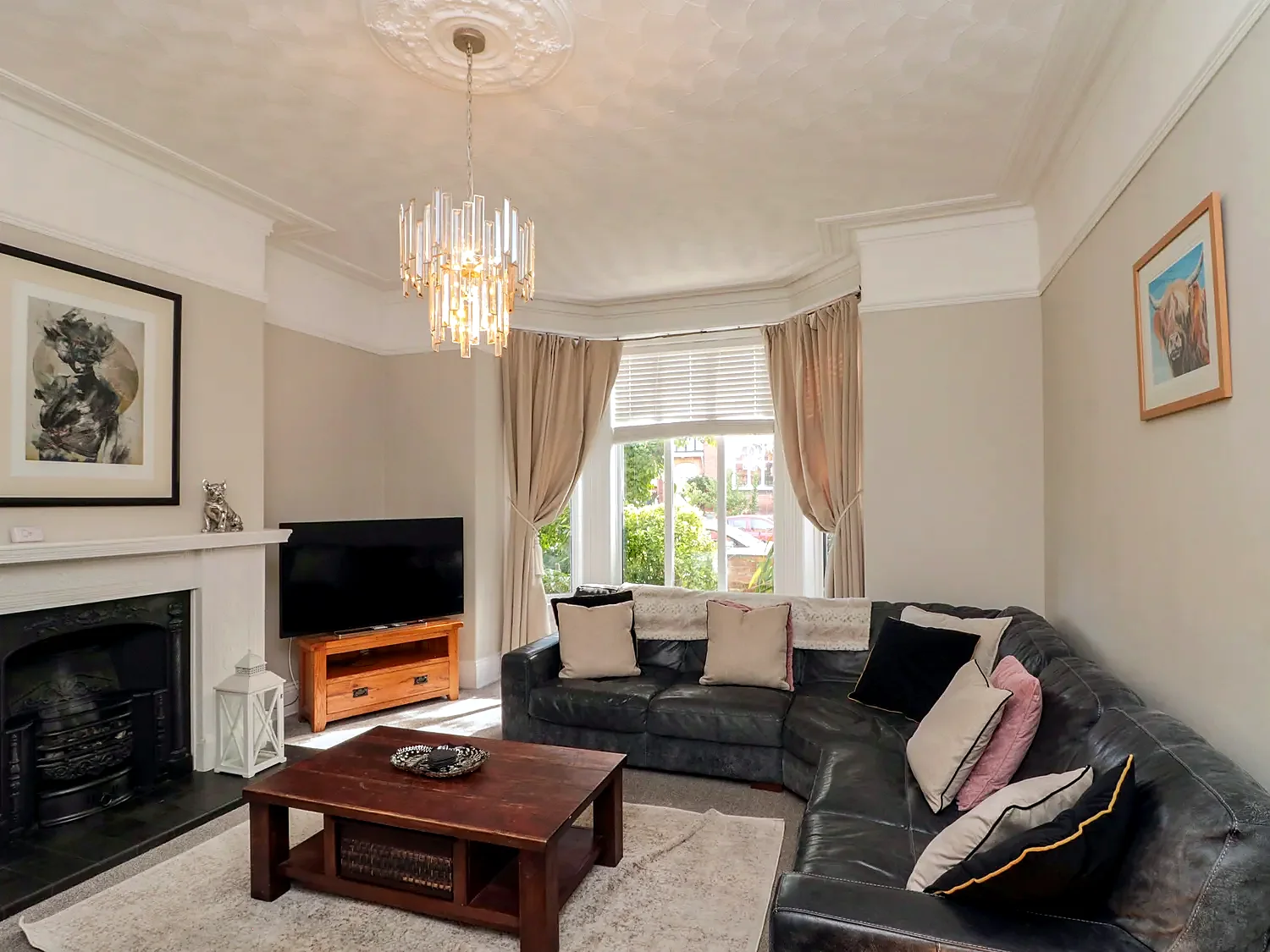 Sitting room with fireplace, sofa seating and warm lighting