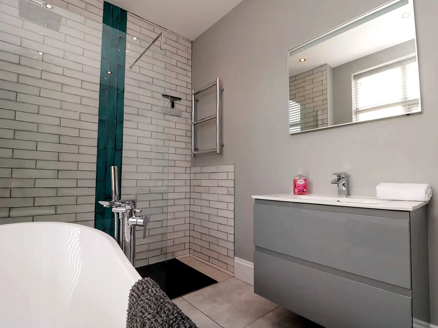 Bathroom with walk-in shower, vanity unit and large mirror