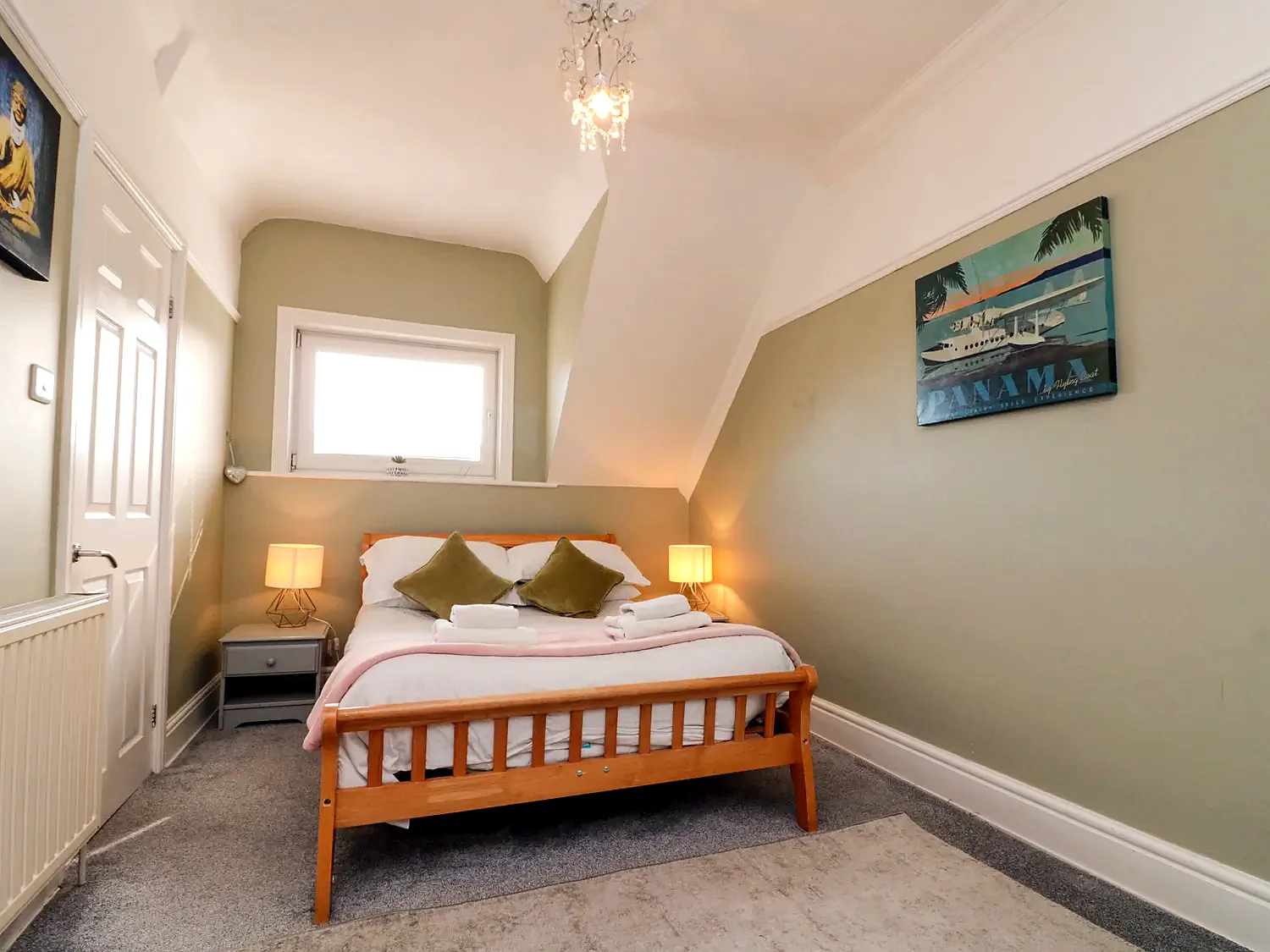Bedroom with two sleeping spaces and a feature pendant light