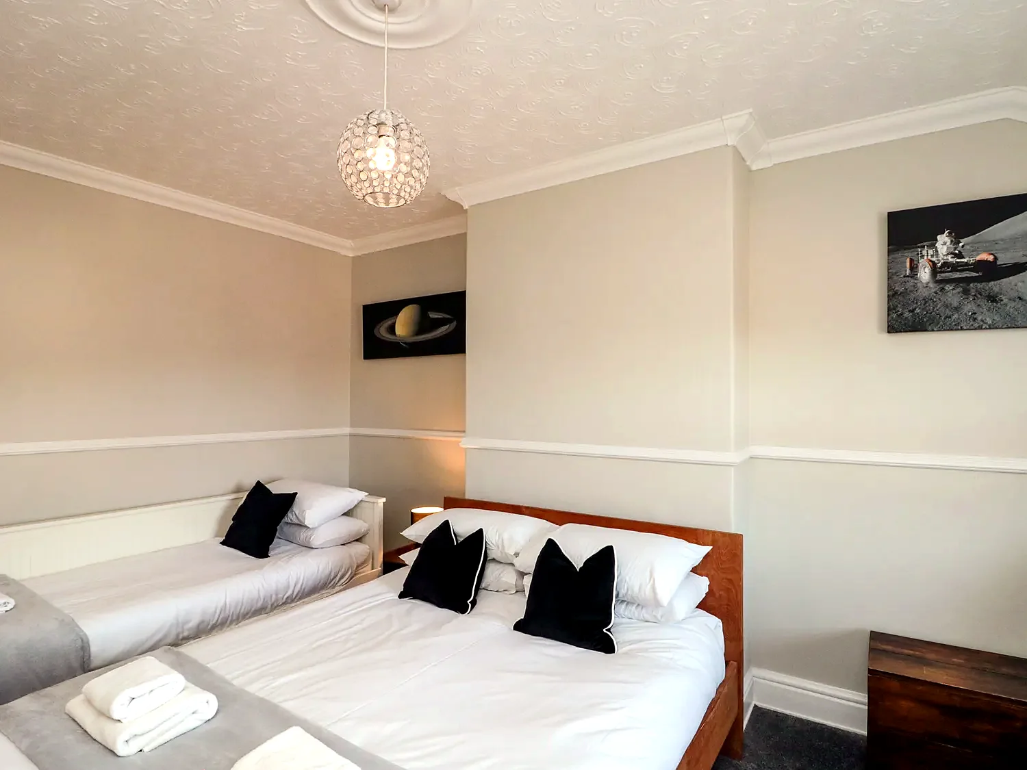 Family bedroom with twin sleeping spaces and fresh white bedding